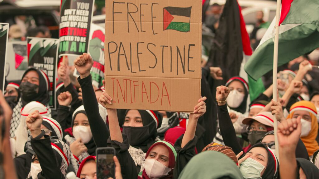 The Effects of the Free Palestine Movement on Gen Z Protesters in Jakarta holding placards supporting Palestine. Social activism and unity.