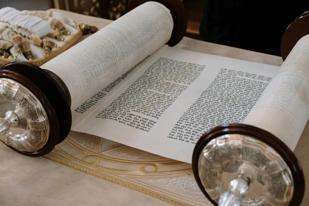 What is the Torah? A close-up view of an open Sefer Torah on a synagogue table, highlighting intricate details.